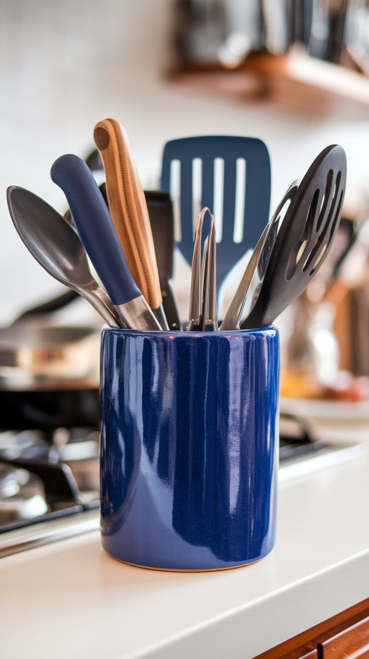 Cobalt blue utensil holder filled with various cooking utensils in a kitchen setting